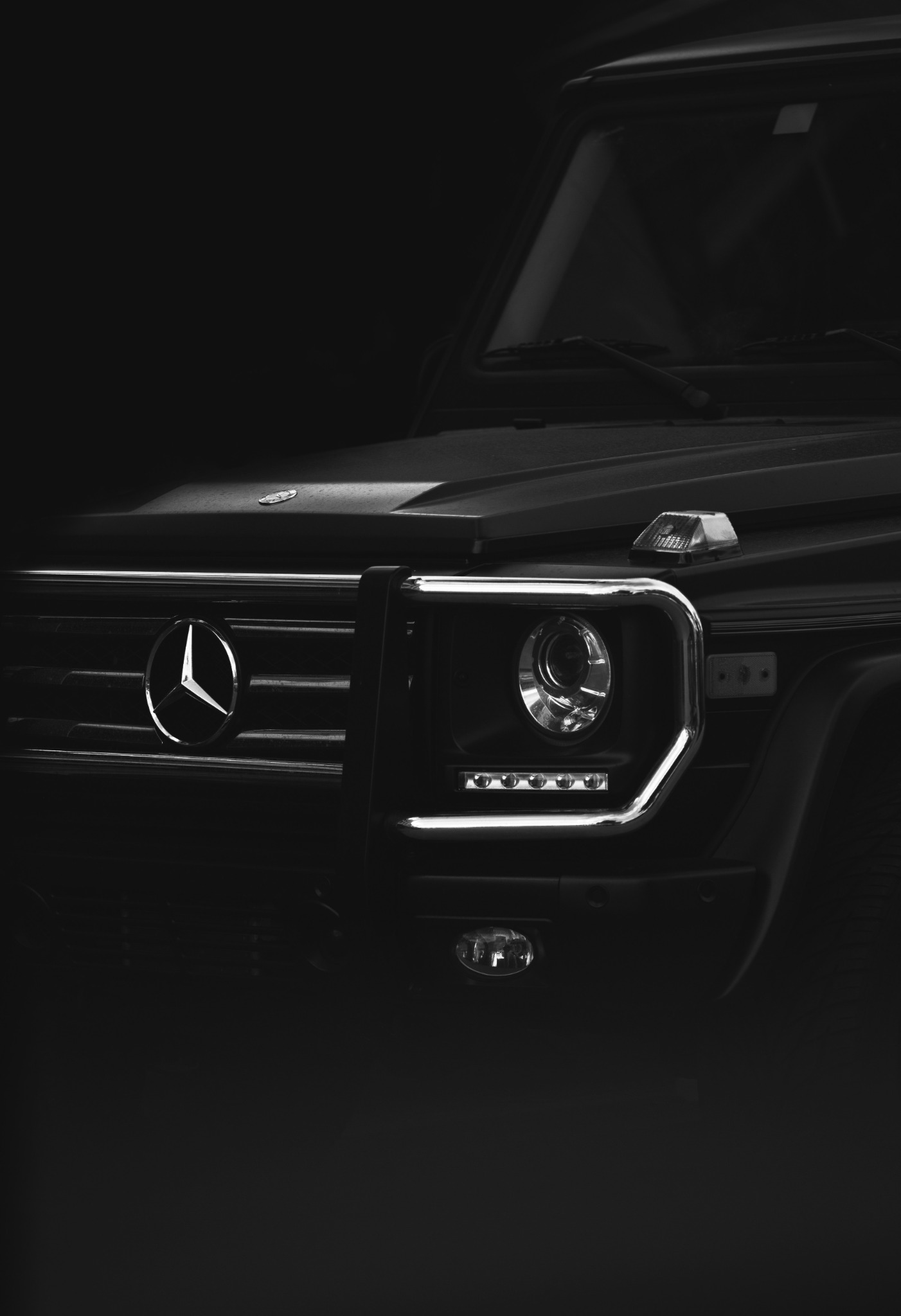 Black Mercedes G-Class front grille and headlight in low light